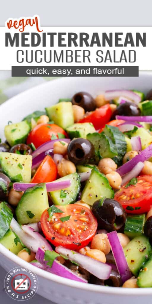 A white serving bowl of Mediterranean cucumber salad with chickpeas.